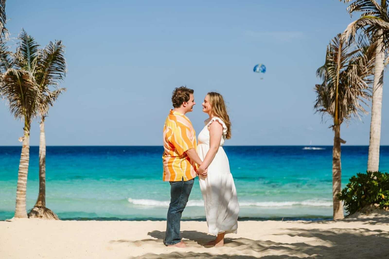 couple on the beach at one of the best tropical honeymoon destinations recommend by CC Vacations